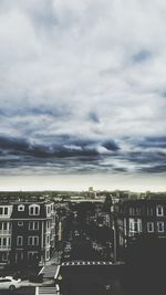 Buildings against cloudy sky