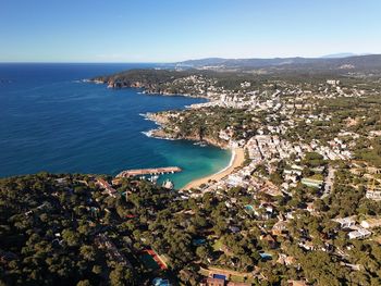 High angle view of townscape by sea against sky