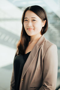 Portrait of smiling businesswoman standing in office