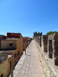 Buildings in city against blue sky