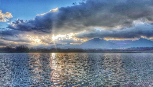 Scenic view of lake against dramatic sky