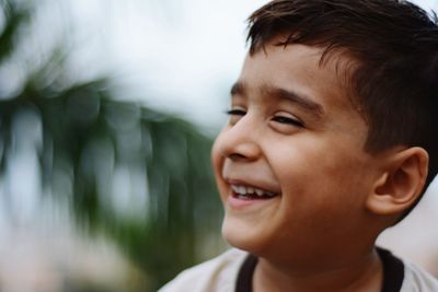 Close-up of boy laughing outdoors