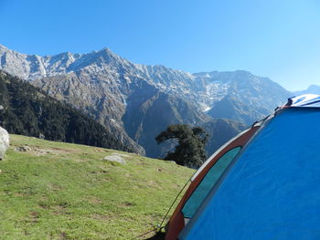 Scenic view of snowcapped mountains against blue sky