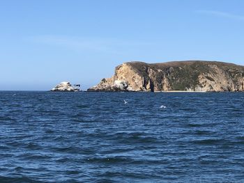 Scenic view of sea against clear blue sky