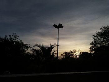 Low angle view of silhouette trees against sky during sunset