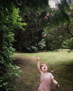 Girl standing on grassy field in park