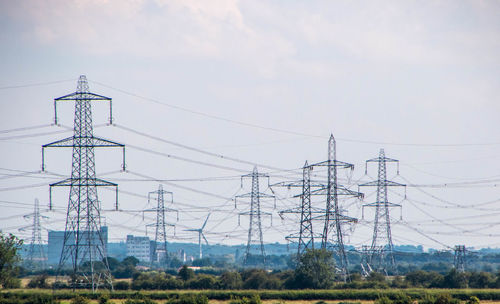 Low angle view of electricity pylon against sky