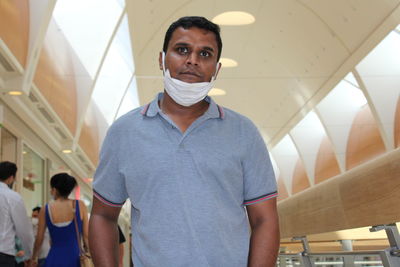 Man wearing mask standing in restaurant