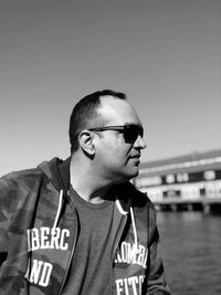 Portrait of mature man standing against clear sky