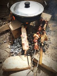 High angle view of meat on barbecue grill