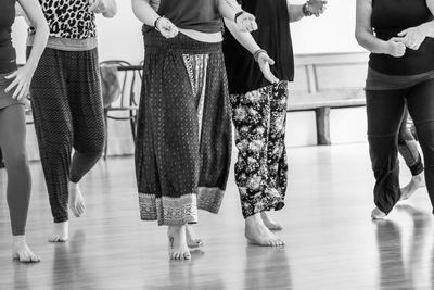 Low section of women dancing on hardwood floor