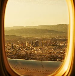 Cityscape against clear sky seen through airplane