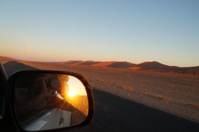 Scenic view of landscape against clear sky during sunset