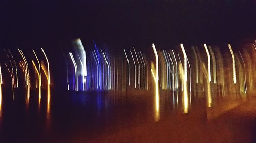 Illuminated firework display at night