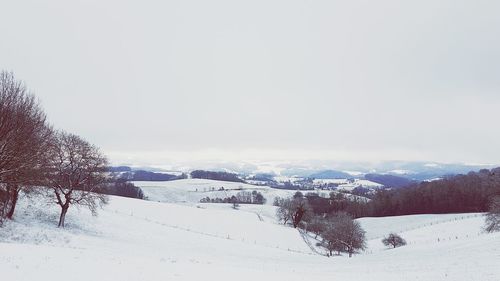 Snow covered landscape against sky