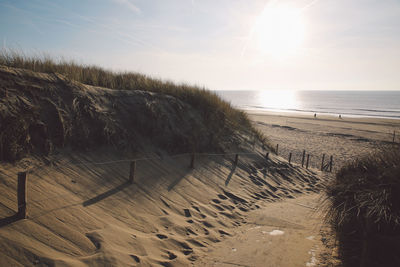 Scenic view of sandy beach against sky