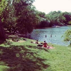 People sitting on riverbank