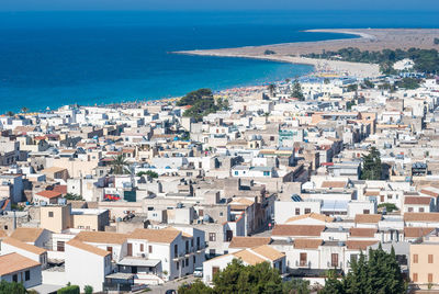 High angle view of townscape by sea