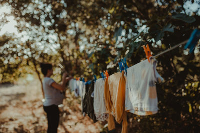 Woman drying laundry on clothesline