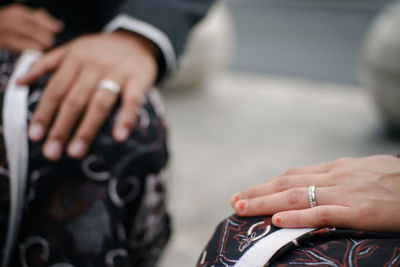 Midsection of couple holding hands