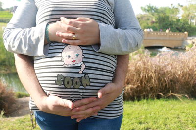 Midsection of pregnant woman with husband