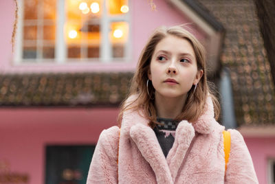 Portrait of a beautiful young woman standing outdoors