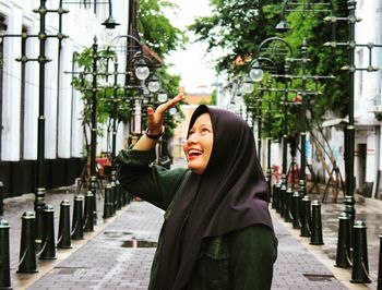 Portrait of smiling young woman standing outdoors