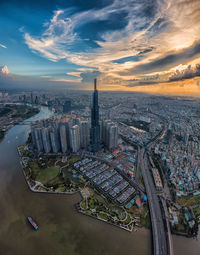 High angle view of city buildings against cloudy sky