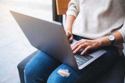 Closeup image of a businesswoman working and typing on laptop computer