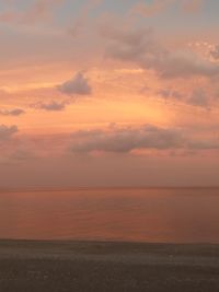 Scenic view of sea against orange sky