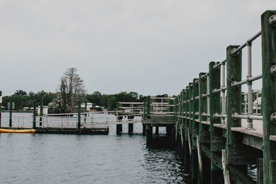 Pier over river against sky