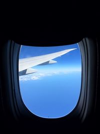 Cropped image of airplane wing over landscape