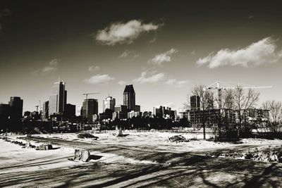 City skyline against cloudy sky