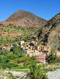 Houses on mountain against clear sky