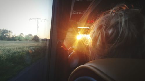 Rear view of woman looking through train window