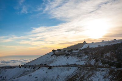 Scenic view of snow against sky during sunset