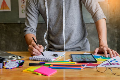 Low section of man working on table