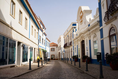 Street amidst buildings against sky