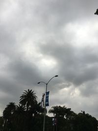 Low angle view of street light against cloudy sky