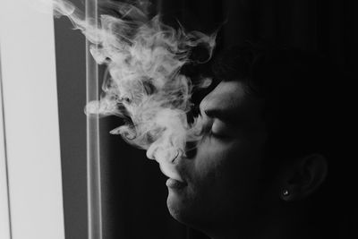 Close-up side view of man smoking