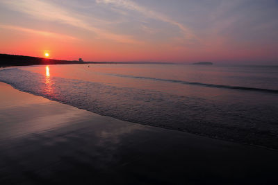 Scenic view of sea against romantic sky at sunset