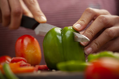 Close-up of hand holding red bell peppers