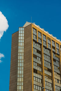 Low angle view of modern building against blue sky