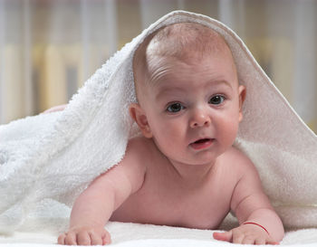 Cute baby boy lying on bed