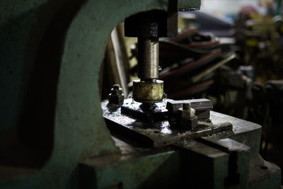 Close-up of rusty machine part in factory