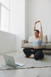 Young woman using laptop at home