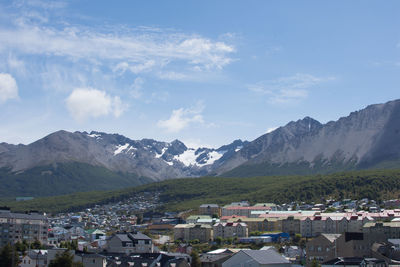 Town by mountains against sky