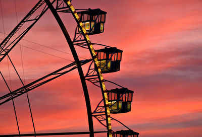 Low angle view of silhouette electricity pylon against sky during sunset