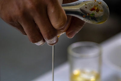 Close-up of hand pouring water in glass