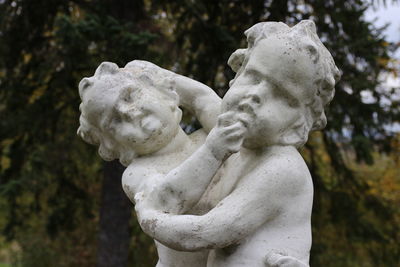 Close-up of statue against trees